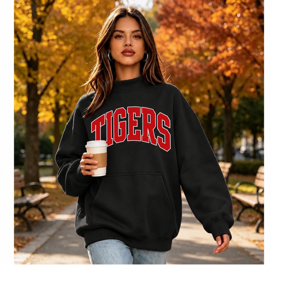 Model wearing a black mockneck sweatshirt with red and white TIGERS lettering